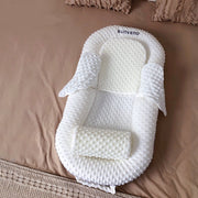 A portable bed for a newborn made of breathable fabric