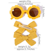 An accessory set for girls includes 2 hair clips and sunglasses