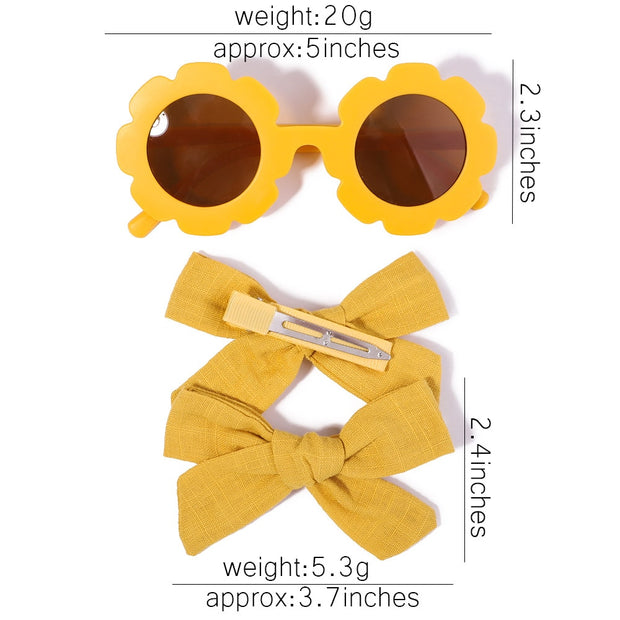 An accessory set for girls includes 2 hair clips and sunglasses